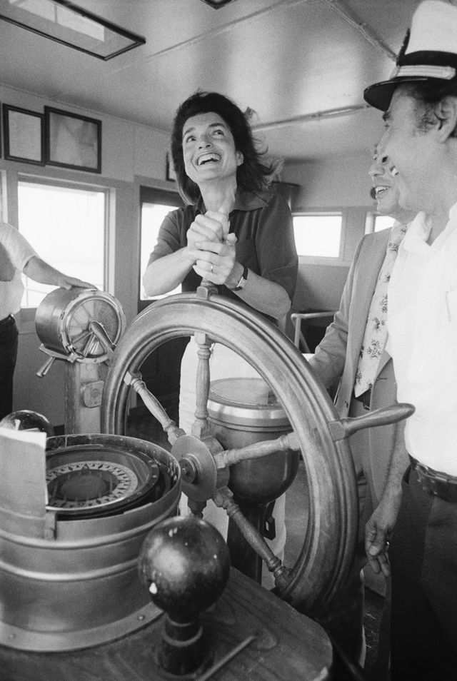 Jacqueline Kennedy Onassis takes a turn at the wheel on board the Staten Island Ferry in 1976.